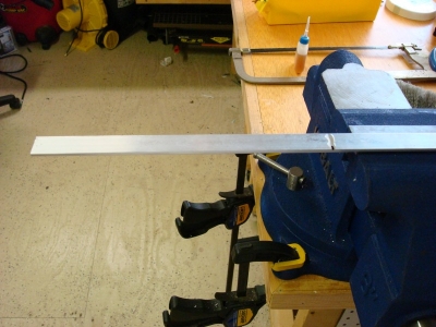 Clamp aluminum in vice, and cut to length 
