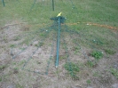 Pick the center pole up and lay it on the ground pointing AWAY from the last stake